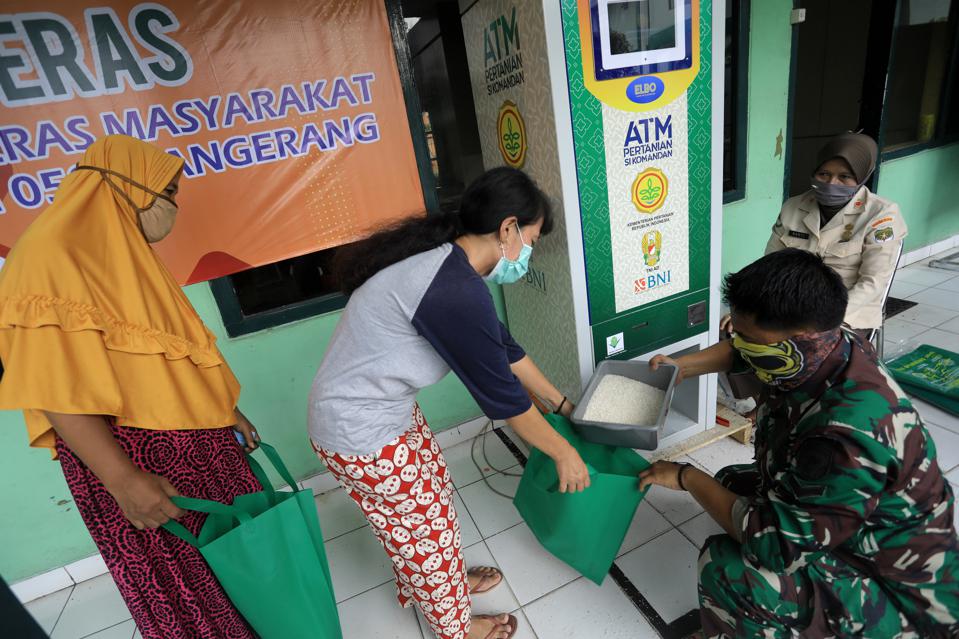 A resident receives free rice at an ATM in Indonesia in 2020 SOPA IMAGES/LIGHTROCKET VIA GETTY IMAGES
